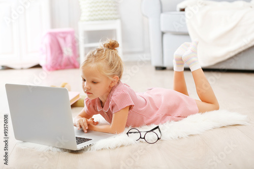 Little girl with laptop in ...