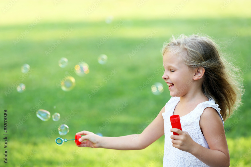 Cute girl blowing soap bubbles Cute girl blowing soap bubbles