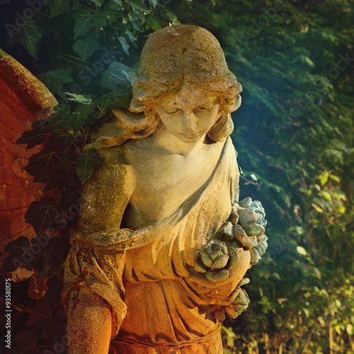 Majestic view of statue of golden angel illuminated by sunlight