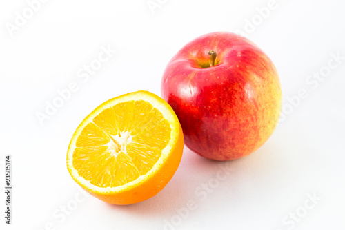 Apple with half orange on white background.