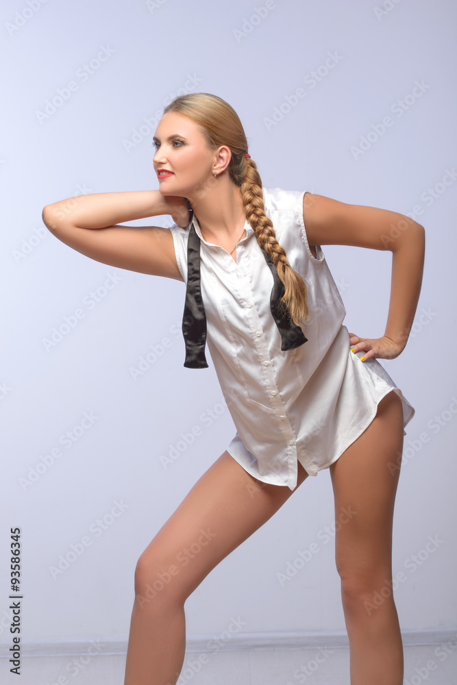 Naklejka premium Attractive young Beautiful blond woman posing in shirt and gesturing 