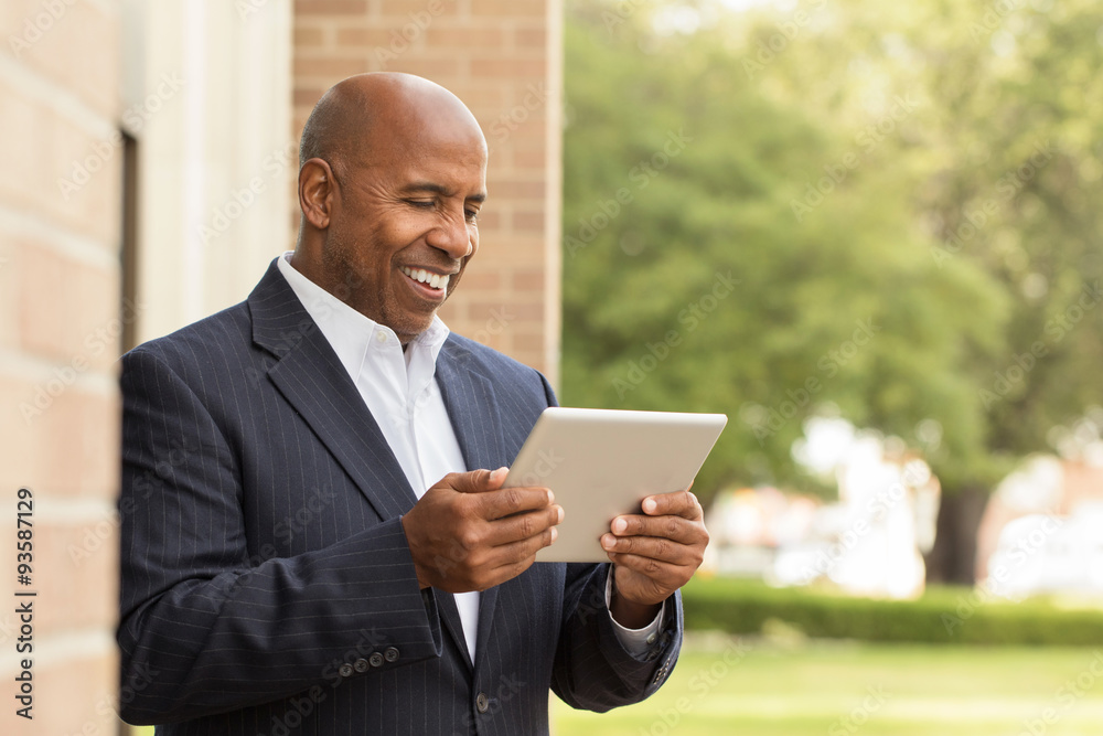 African American businessman working on social media. African American businessman working on social media.