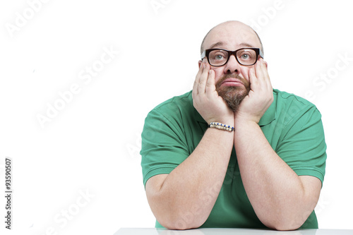 Sad man sitting at the table..