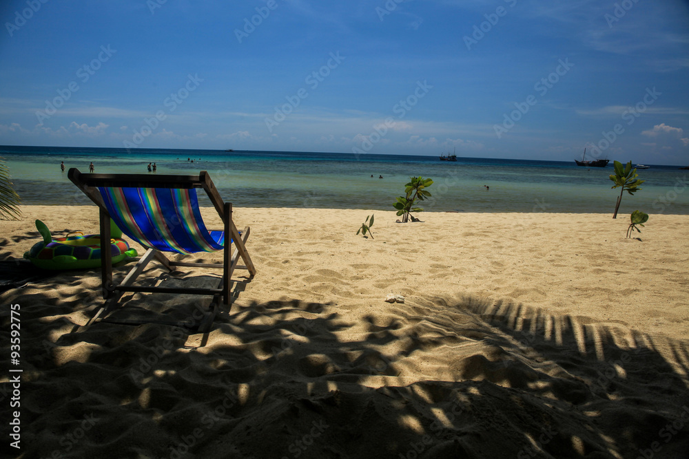 Relaxing beach chair on tropical white sand beach - (Close-up). It's intended to show freedom of lifestyle.