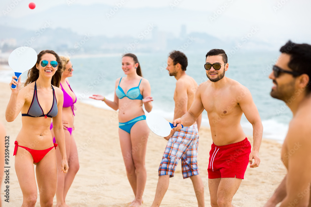 Tourists playing beach paddle games