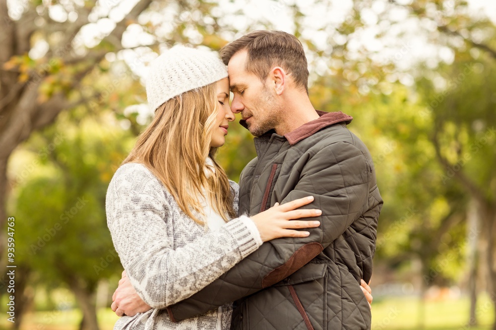 Fototapeta premium Portrait of smiling young couple embracing