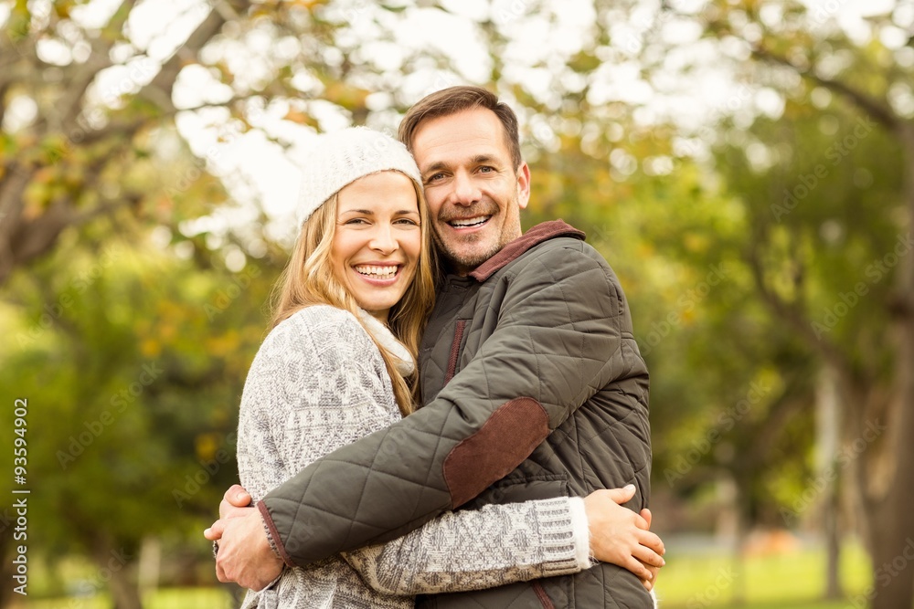 Portrait of smiling young couple embracing