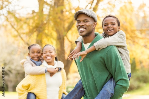 Portrait of a young smiling family in piggyback