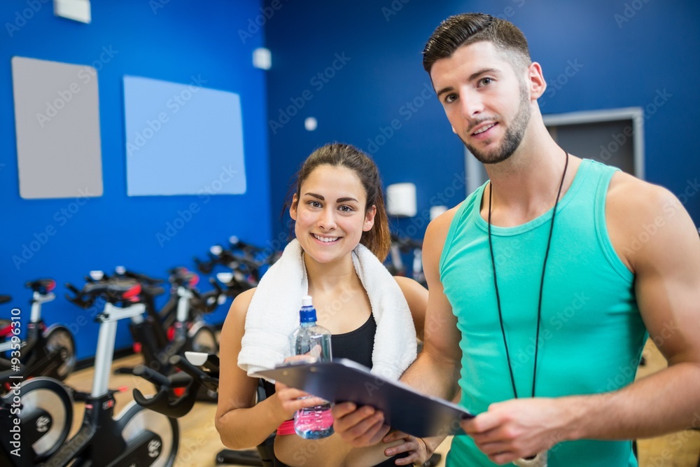 Trainer and athlete reading workout plan Trainer and athlete reading workout plan