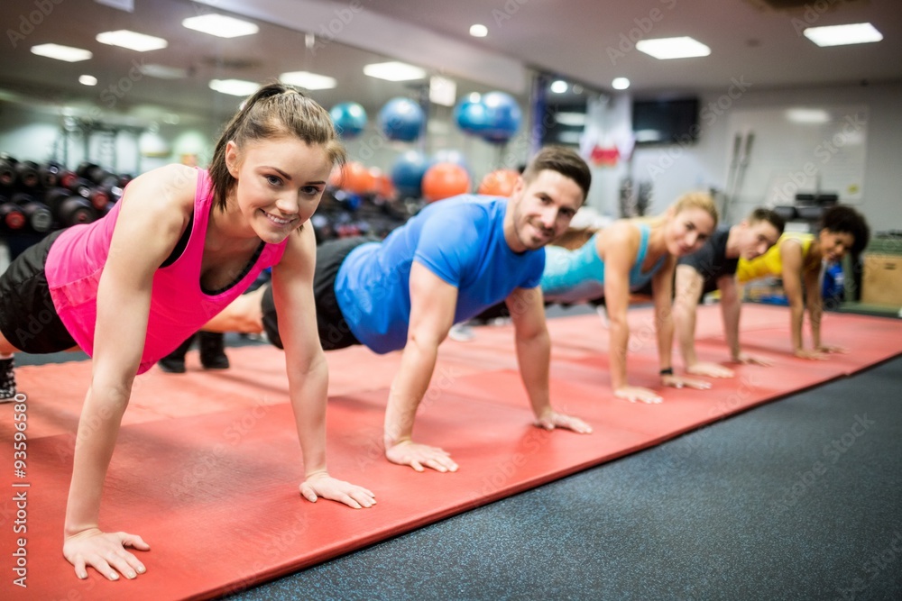 Obraz premium Fit people working out in fitness class