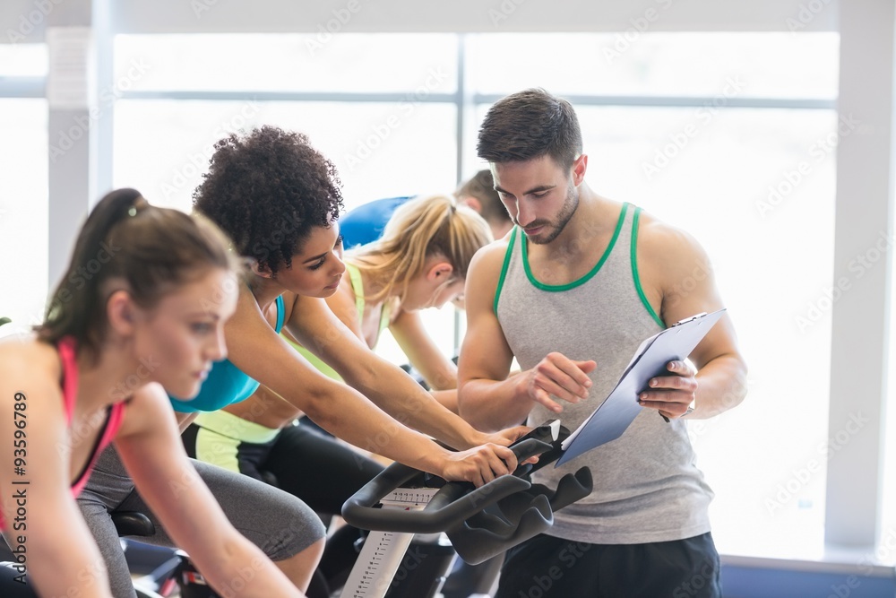 Fit people in a spin class Fit people in a spin class