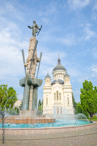 Orthodox Cathedral and national hero Avram Iancu statue in Cluj Napoca, transylvania region of Romania on a sunny summer day. Beautiful romanian church