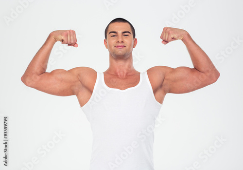 Happy muscular man showing his biceps