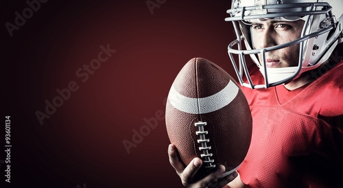 Composite image of confident american football player with ball