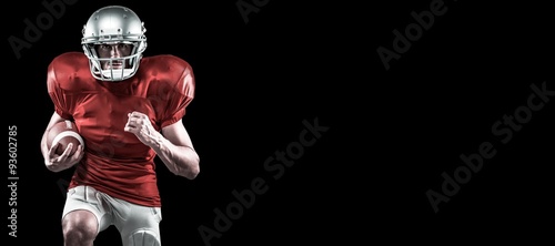 American football player running while holding ball