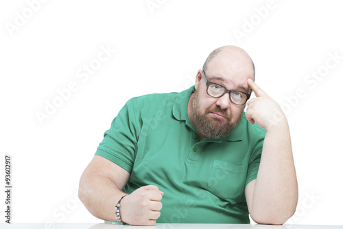Funny man holding his head and hitting his fist on the table..