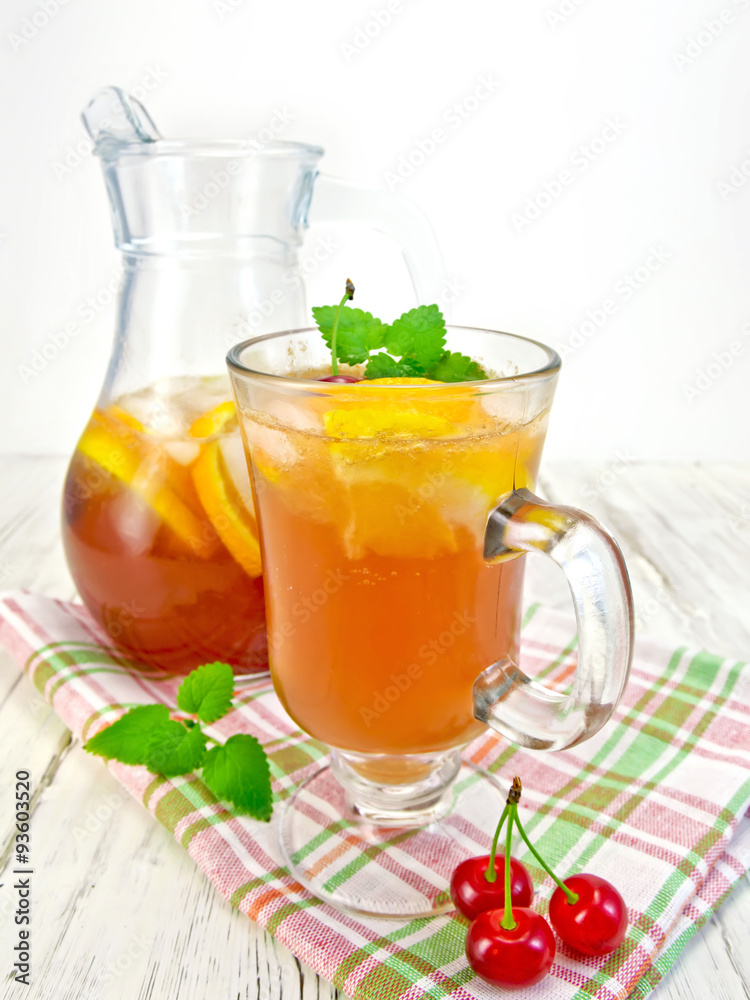 Lemonade with cherry in wineglass and pitcher on board Lemonade with cherry in wineglass and pitcher on board