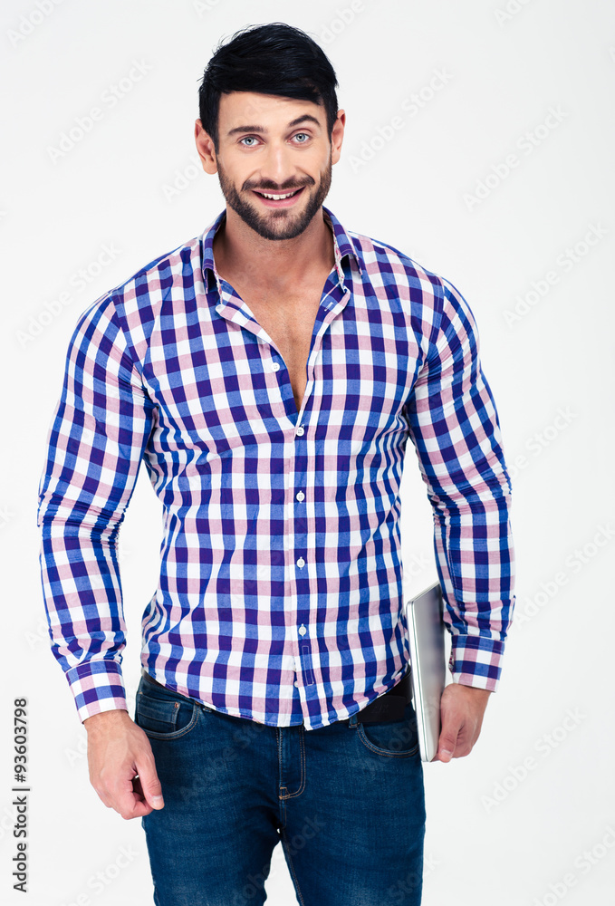 Fototapeta premium Smiling handsome man holding laptop computer