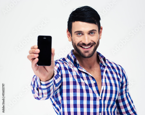 Smiling man showing blank smartphone screen © Drobot Dean
