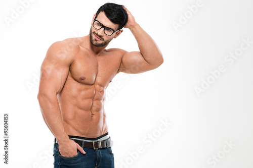 Thoughtful muscular man in glasses looking away photo