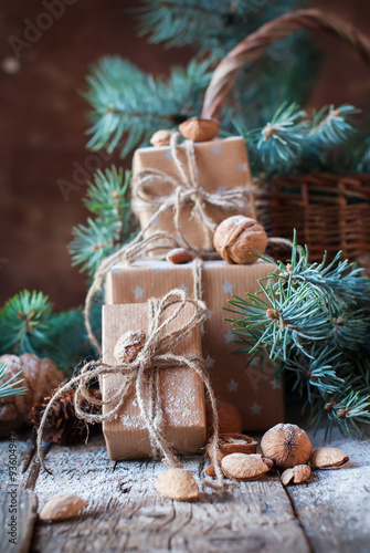 Christmas Boxes, Coniferous, Pine Cones, Fir Tree, Basket, Walnuts, Almonds on Wooden Background. Presents in Vintage Style