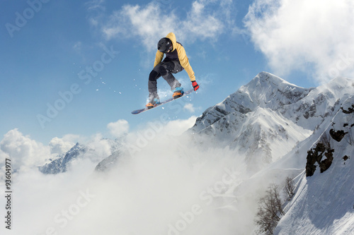 Flying snowboarder on mountains