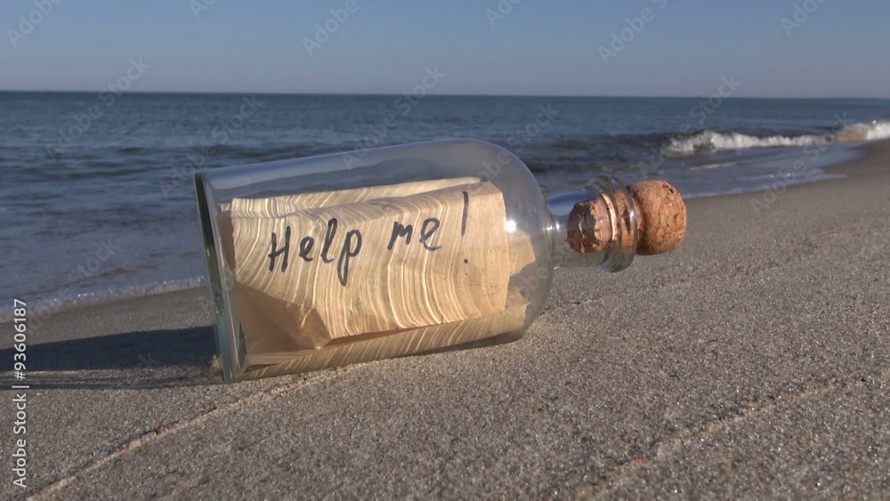 Seascape with transparent bottle with a message “help me” in the sand
