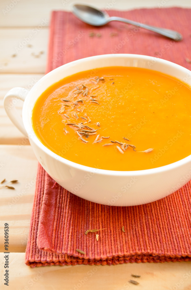 Vegetarian carrot-pumpkin cream soup with garlic and cumin