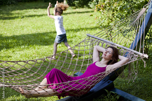 Mother and daughter are enjoying on hammock at park
