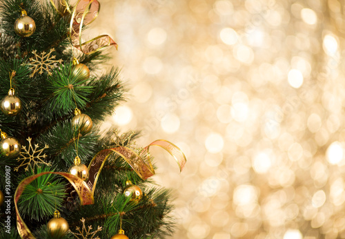 Christmas tree background with gold blurred light photo