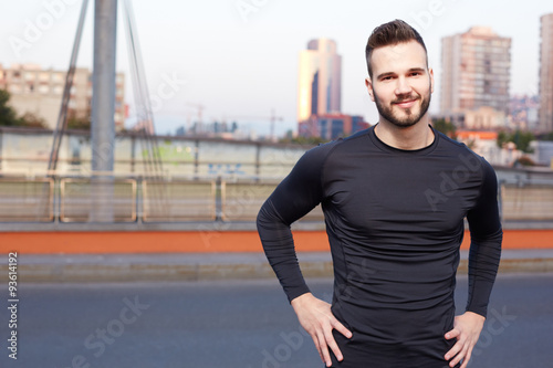 Portrait of smiling man resting after workout outdoors, fit cauc