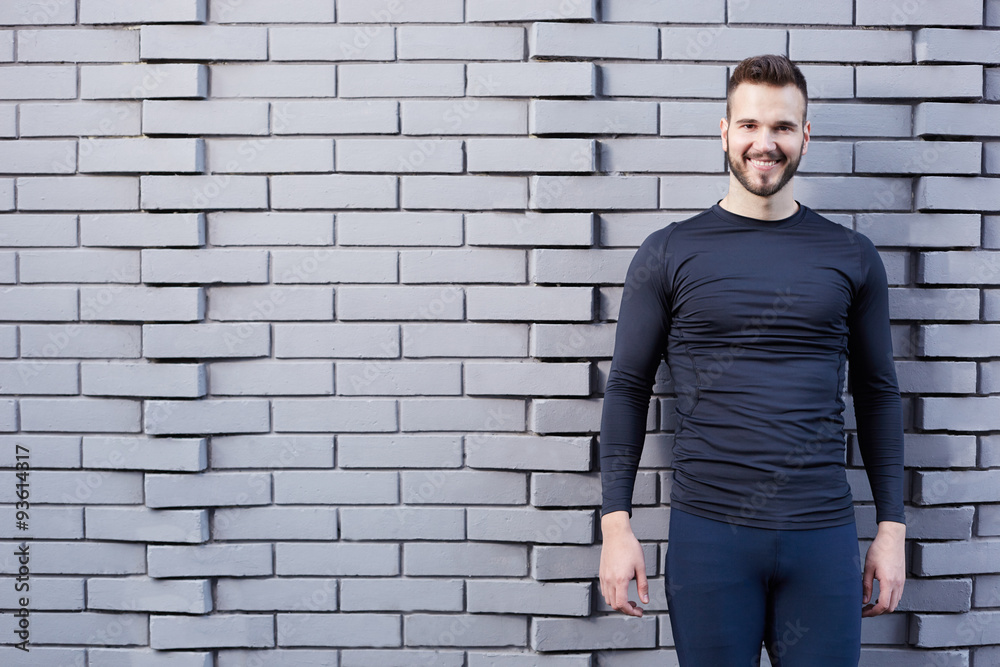 Portrait of smiling man resting after workout outdoors, fit caucasian Portrait of smiling man resting after workout outdoors, fit caucasian