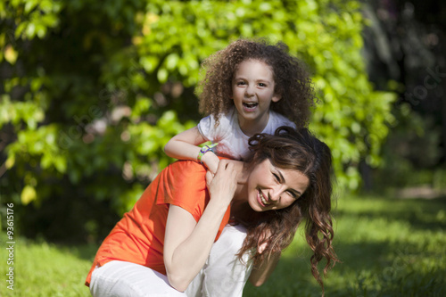 Mother and daughter are enjoying on grass at park