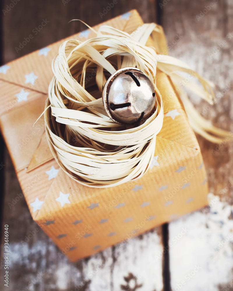 Fototapeta premium Christmas Box with Jingle Hand Bell and Natural Twine. Toned