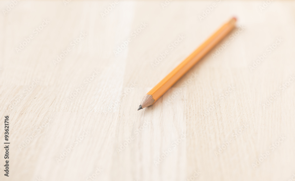 Yellow pencil on wooden table Yellow pencil on wooden table