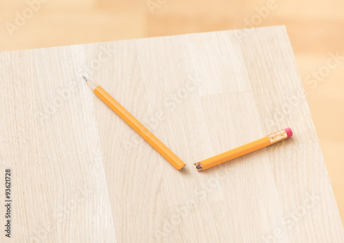 Broken pencil on wooden table