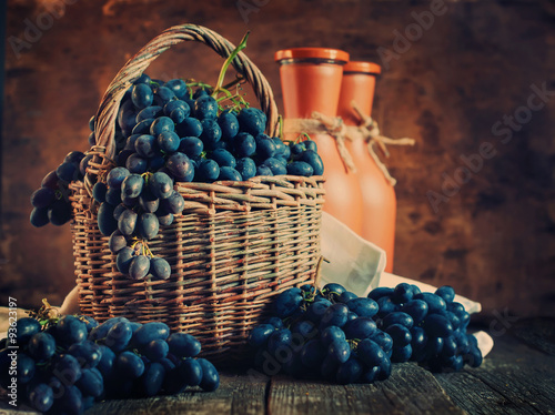 Blue Grapes in Rural Basket on Wooden Background