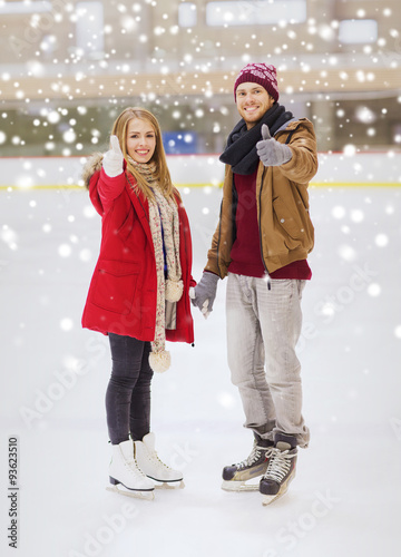 happy couple holding hands on skating rink