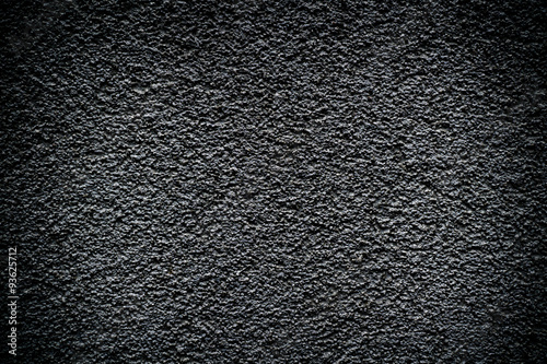 Black revetment wall putty high contrasted with vignetting effect macro texture background