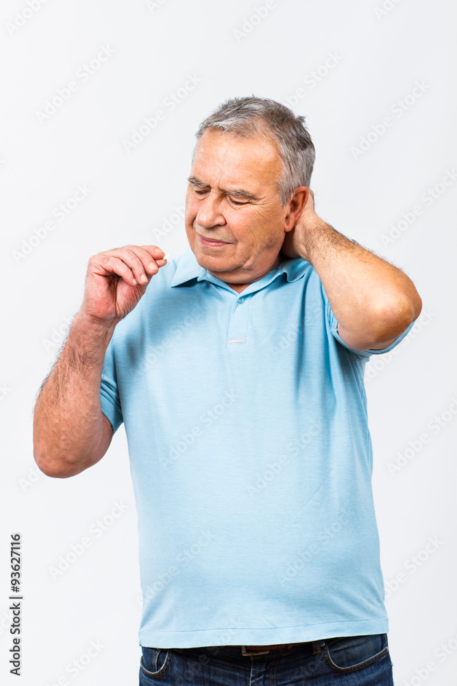 Senior man taking pills for pain in neck Senior man taking pills for pain in neck