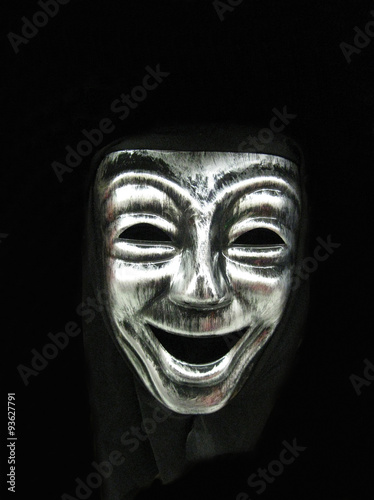 Smiling carnival face mask, part of a Halloween costume, with space for text.