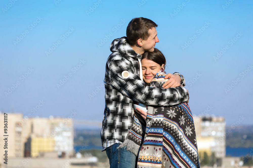Young Couple Embracing Warming Plaid