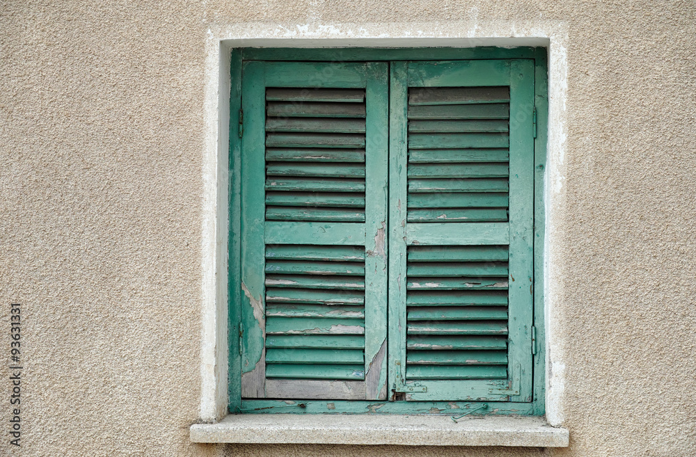 Old window with closed shutters