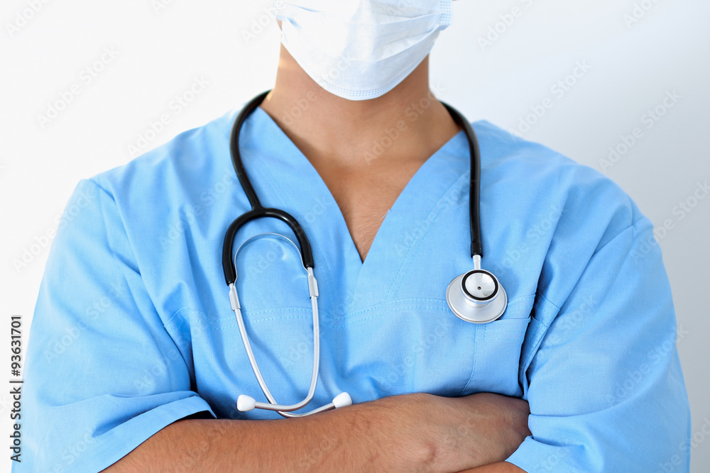 Portrait of unknown male surgeon doctor holding his stethoscope, crossed arms Portrait of unknown male surgeon doctor holding his stethoscope, crossed arms