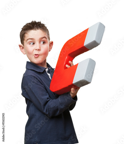 little kid holding a magnet