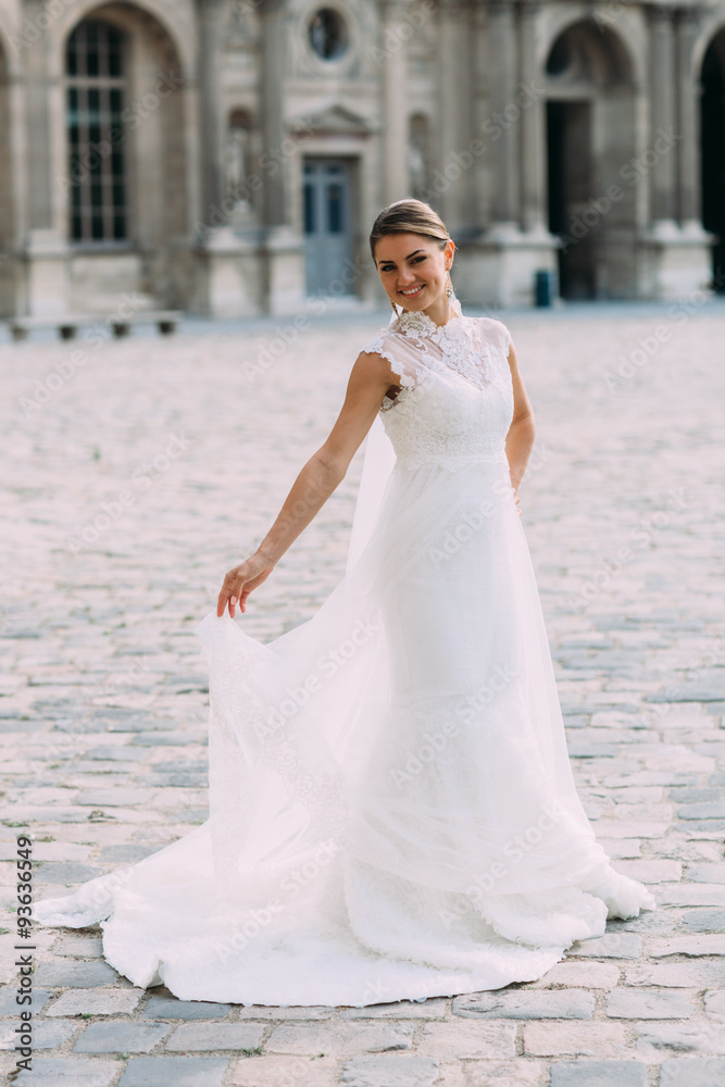 incredibly beautiful bride in a simple elegant long dress with a long veil in Paris