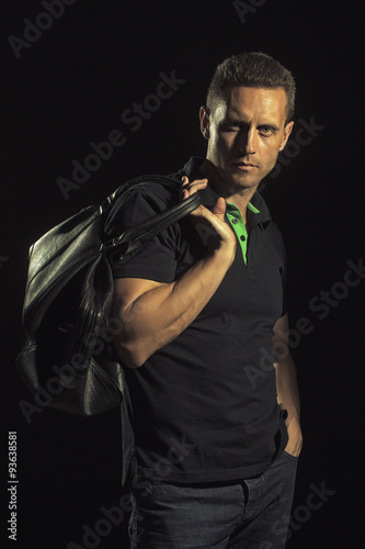 Strong muscular man with bag