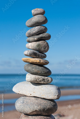 Stones pyramid on beach symbolizing harmony balance