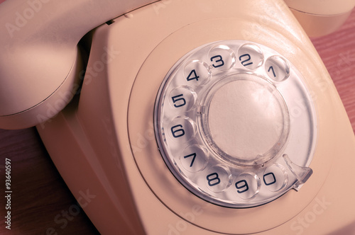 Retro telephone on wooden table in front gradient background