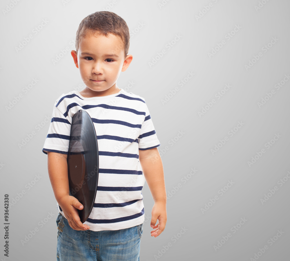 portrait of a little boy holding a vinyl record portrait of a little boy holding a vinyl record